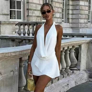 Model wearing a stylish backless halter neck dress at an elegant outdoor location.